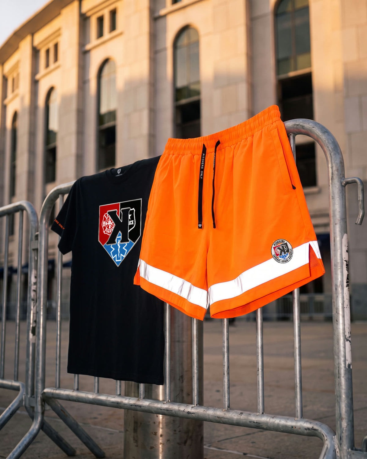 First Responders Tee and Safety Orange Shorts hung on a police barricade outside Yankee Stadium