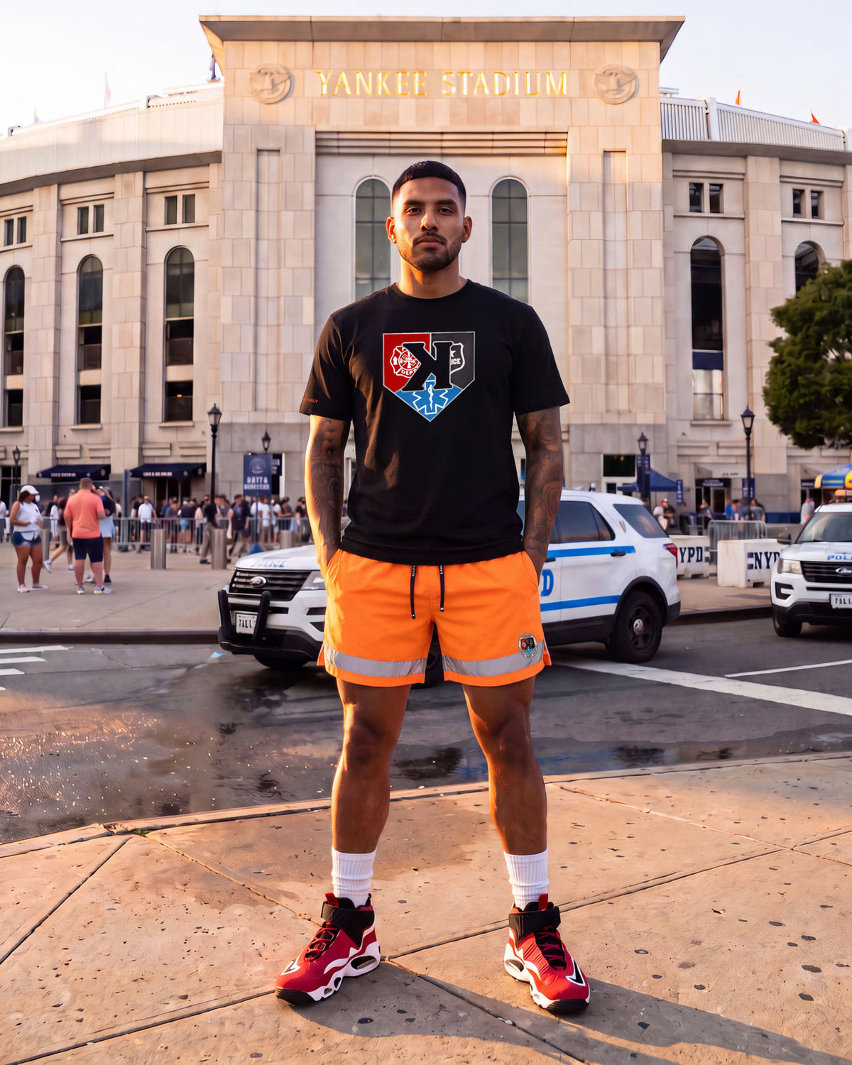 Model in the First Responders Tee and Safety Orange First Responders Shorts outside Yankee Stadium
