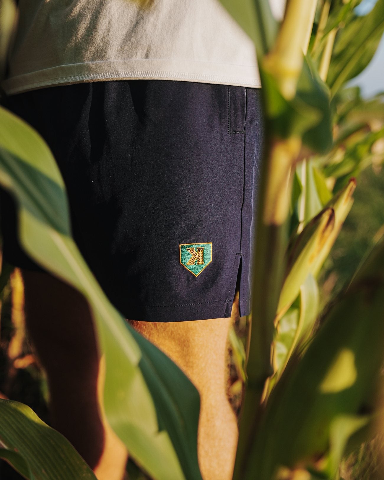 Close detail of the gold shield on the Mound of Dreams Shorts