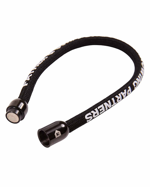 Pitchers Only bracelet shown unclasped, magnetic barrel clasp open on braided black cord with raised white lettering