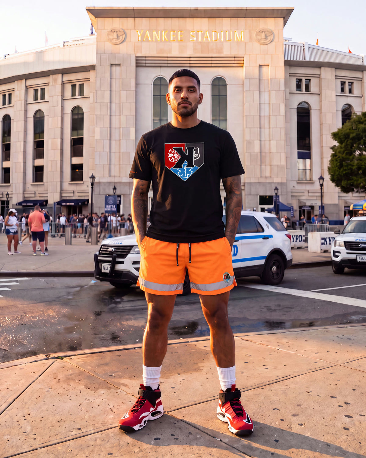 Model in the First Responders Tee and Safety Orange First Responders Shorts outside Yankee Stadium