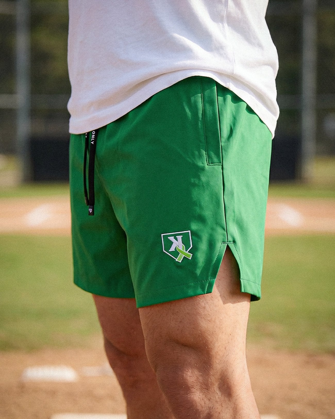 Youth One Pitch Shorts in Kelly Green, front view with embroidered K