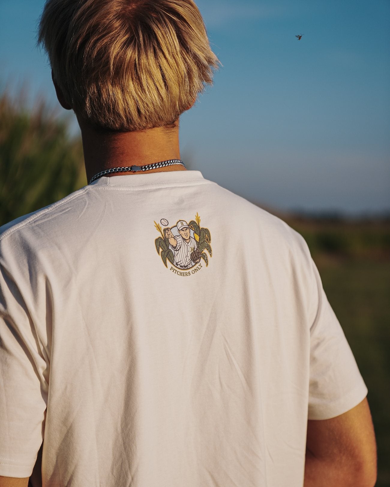 Back crest of the Mound of Dreams Tee worn at golden hour