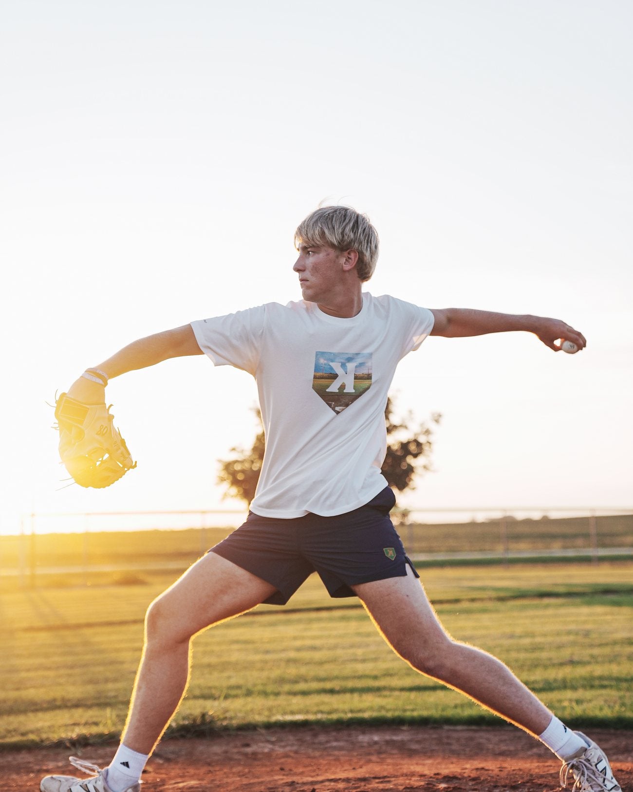 Pitcher mid delivery wearing the Mound of Dreams Tee